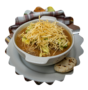 This picture features a very appetizing traditional Colombian soup. it's inside a bowl and the bowl in on a plate. On the plate there is an Arepa to add the cherry on top to this delicious plate